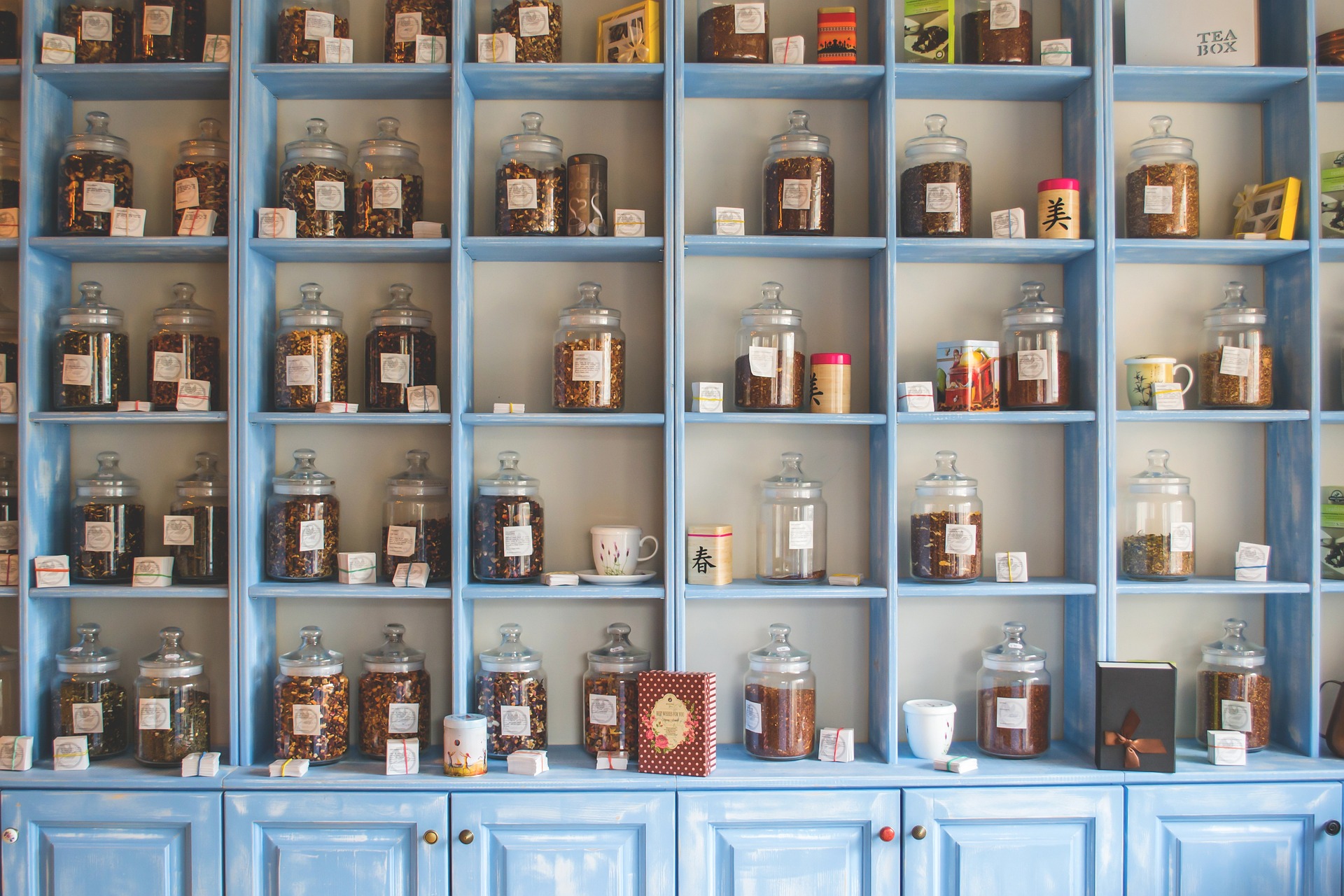 A shelf of oddities with jars and herbs